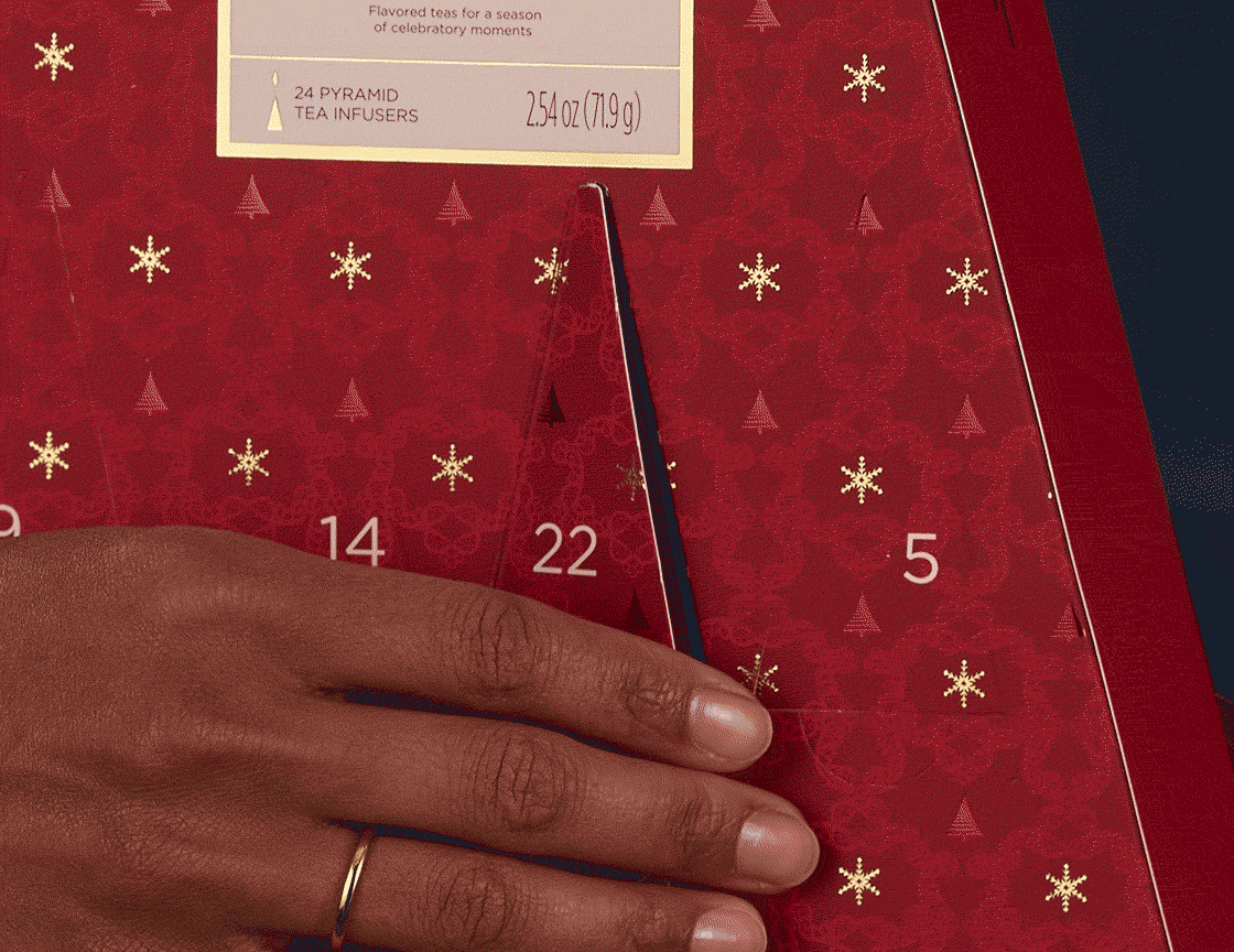 Warming Joy Advent Calendar Assorted, animation showing hand opening one of the doors to reveal a pyramid infuser