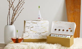 Winter Chalet collection tea packaging with a cup of tea on a white furry surface